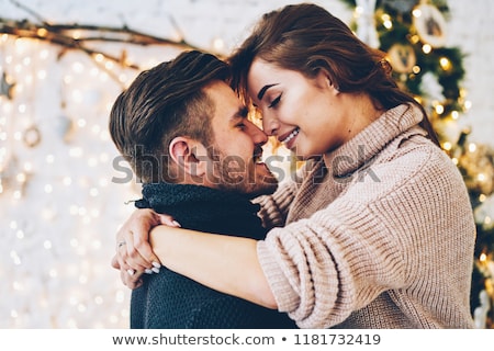 Foto stock: Happy Couple Hugging At Christmas Tree