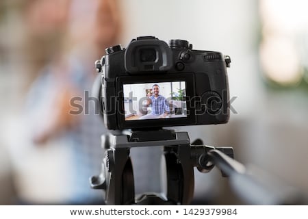 Foto d'archivio: Male Blogger With Camera Videoblogging At Home