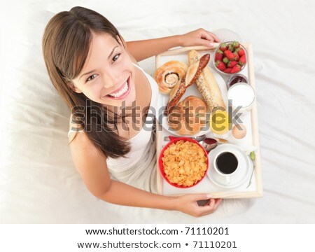 Cheerful Girl Having Breakfast In Bed Stock fotó © Ariwasabi