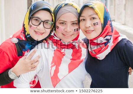 Stock photo: Young Woman Travels In Malaysia Holds The Malaysian Flag