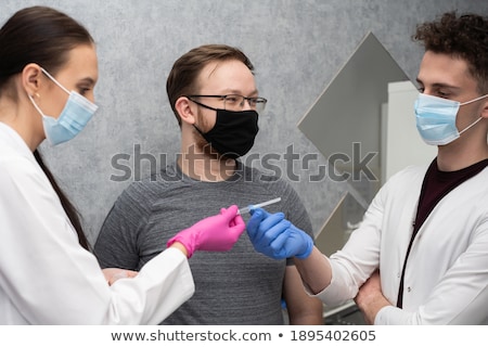 Foto stock: Men Working On A Sterilizing Place In The Hospital Placing A Chariot