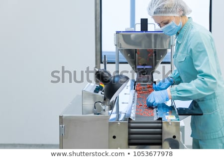 Stok fotoğraf: Pharmacy Industry Woman Worker In Protective Clothing Operating Production Of Tablets In Sterile Wor