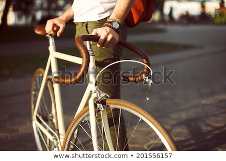 Foto d'archivio: Young Hipster Man Riding Fixed Gear Bike