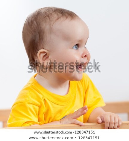 Foto stock: One Years Girl Baby On The Side Of The Bed