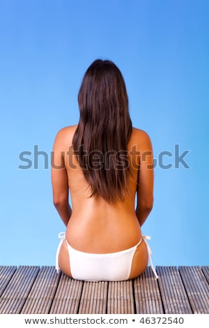 ストックフォト: Back View Of Long Haired Young Woman In Swimsuit