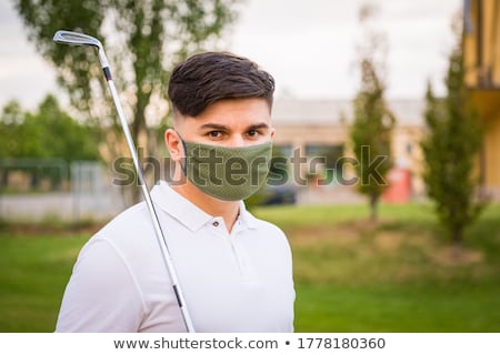 Stock photo: Man Wearing Medical Mask And Plays Tennis Coronavirus Pandemic Covid 19 Sport Active Life In Quar