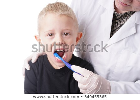 Stockfoto: Boy Gets Help By The Dentist To Brush His Teeth