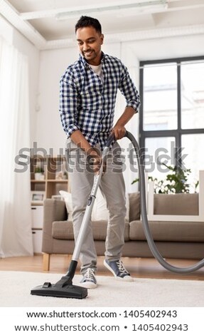 ストックフォト: Indian Man With Vacuum Cleaner At Home