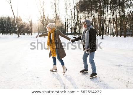 Foto d'archivio: Couple In Sunny Winter Nature Ice Skating