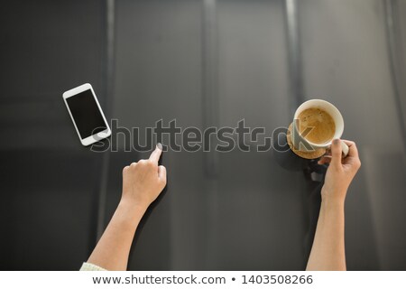 Foto d'archivio: Woman With Coffee Using Black Interactive Panel
