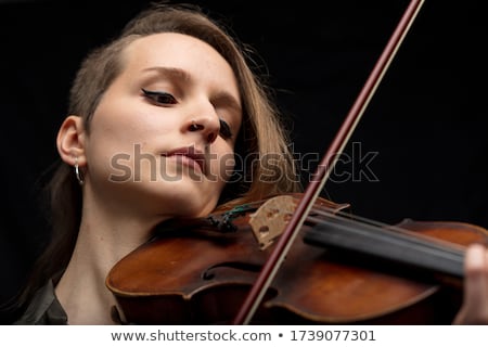 Stok fotoğraf: Dedicated Female Violinist Playing Baroque Violin