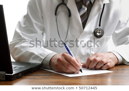 Foto stock: Writing A Prescription Or Medical Examination Notes