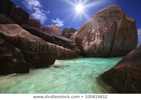 [[stock_photo]]: Giant Rocks Rolled Down To The Oceans Shore And Beautiful Sun