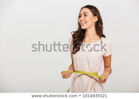 Stock photo: Woman Measuring Waist With A Tape Measure Isolated On White