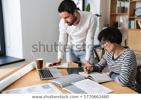Stockfoto: Concentrated Thinking Man In Office Coworking While Using Laptop