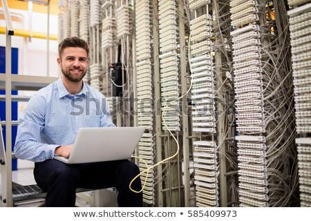 Foto d'archivio: Technicians Using Laptop While Analyzing Server