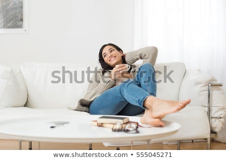 Stock foto: Young Woman Relaxing On Couch