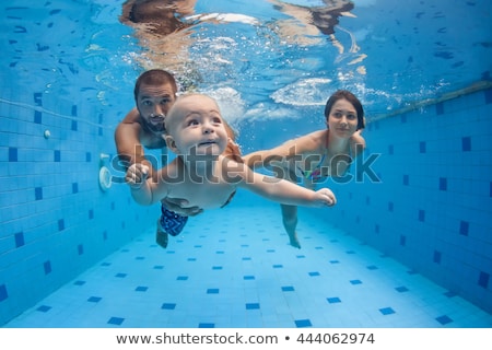 Stock foto: Father Teaching Small Child Swimming Underwater In The Pool