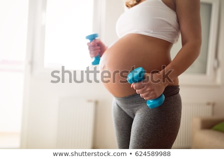 Stockfoto: Pregnant Woman Training With Dumbbells To Stay Active