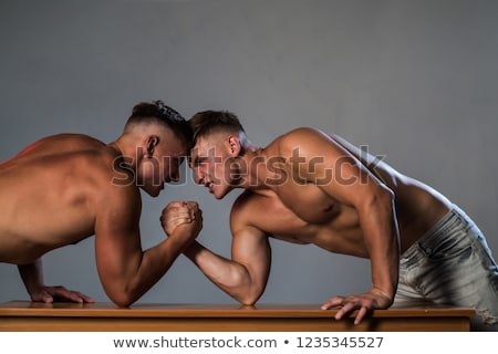 Stock photo: Brothers Compete In Arm Wrestling