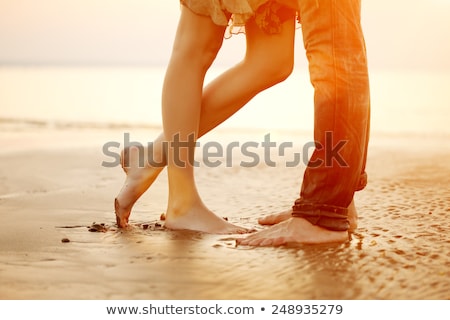 Stock fotó: Young Couple In Love Near The Ocean At Sunset