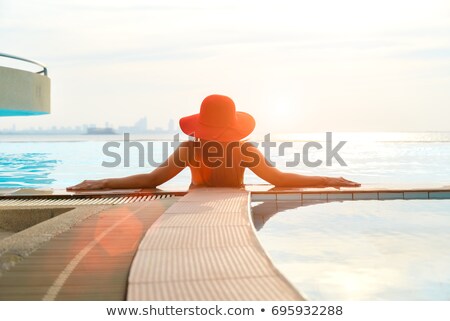 [[stock_photo]]: Beautiful Young Women Drinking A Cocktails In The Swimming Pool