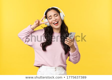 Foto stock: Asian Woman In Headphones Listening To Music