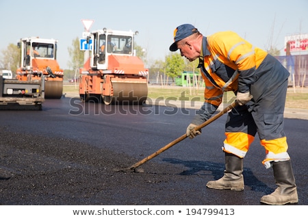 Foto stock: Workers On Asphalting Road