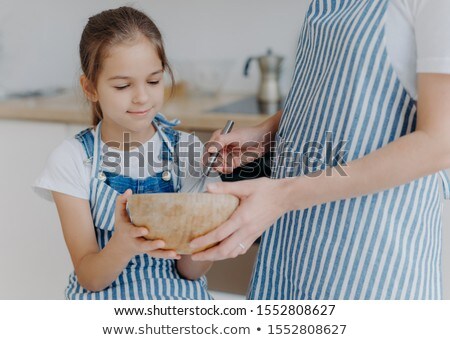 Сток-фото: Busy Little Girl Hold Bowl Looks How Mother Whisks Ingredients Learns How To Cook Unrecognizable