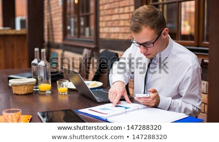 [[stock_photo]]: Hard Working Businessman In Restaurant Close Up