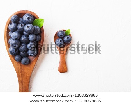 Foto stock: Fresh Raw Organic Blueberries With Leaf On Mini Wooden Spoon On White Background Food Concept