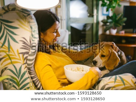 Stok fotoğraf: Happy Woman Eating Popcorn At Home