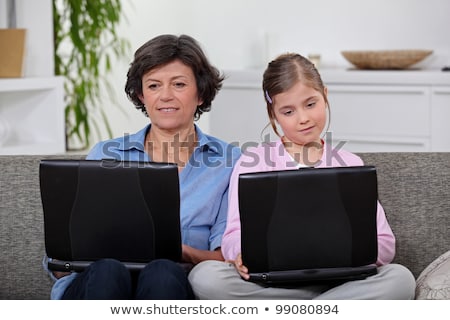 Foto d'archivio: Mother And Daughter Each With Their Own Laptop