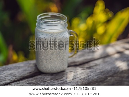 Stock fotó: Healthy Layered Dessert With Chia Pudding In A Mason Jar On Rustic Background