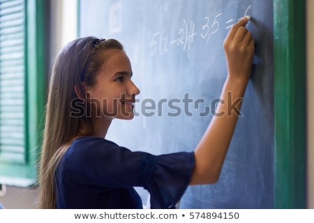 Foto stock: Student In School Doing Exercise At The Blackboard