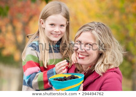 Stok fotoğraf: Mother And Daughter Sharing Blackberries