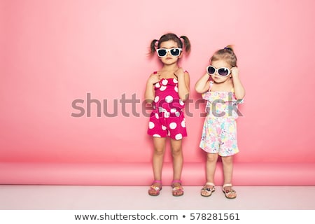 Stok fotoğraf: Fashionable Twins Sisters Posing On Pink Background