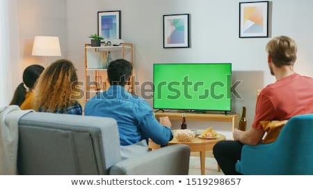 Foto stock: Happy Friends With Drinks Watching Tv At Home