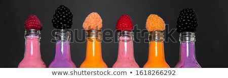 [[stock_photo]]: Banner With Six Bottles With Smoothies And Raspberry Red Yellow Blackberry On Black Background