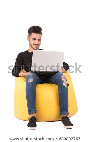 [[stock_photo]]: Young Smiling Arab With Laptop Isolated On White