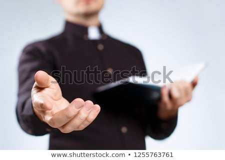 Foto d'archivio: Young Priest With Bible Isolated On White