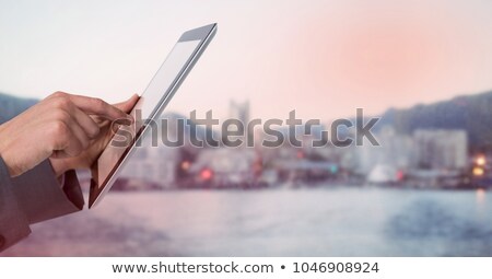 Stock photo: Composite Image Of Cropped Hand Of Man Holding Digital Tablet