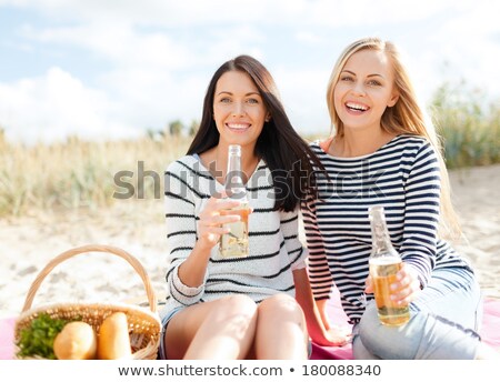 Foto stock: Girl Sitting On Picnic Basket On Beach