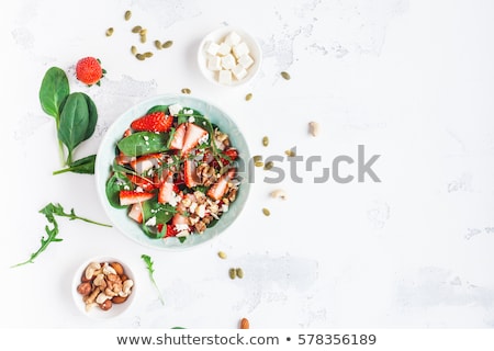 Stockfoto: Fresh Salad With Arugula Strawberries Feta Cheese And Nuts