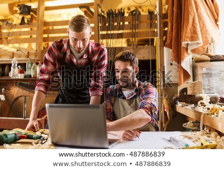 Stock fotó: Carpenters With Laptop And Blueprint At Workshop