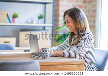 Foto stock: Happy Senior Woman With On Laptop Computer At Home