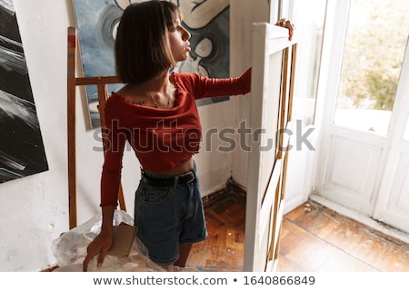 ストックフォト: Portrait Of Woman Holding Blanc Paint Canvas While Drawing In St