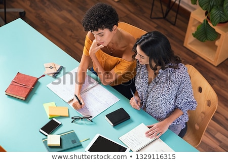 Stok fotoğraf: Two Students Reading And Studying In Library