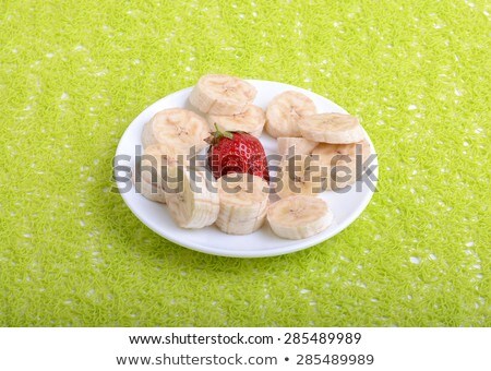 Bunch Of Bananas And Several Strawberries On White Plate Stockfoto © fotoscool