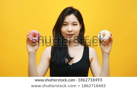 Foto stock: Confused Diet Young Woman Holding Tasty Donut